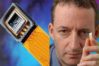 An image of Professor Ian Underwood of MED with a with a large polymer OLED.